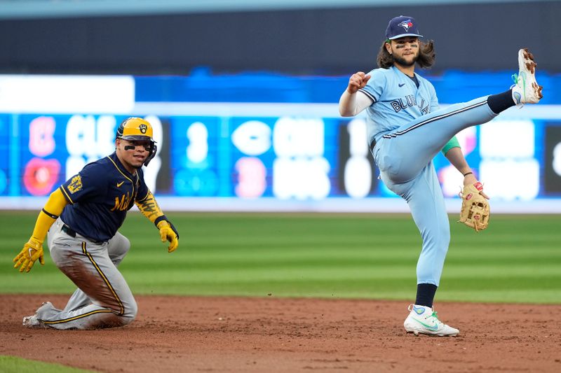 May 30, 2023; Toronto, Ontario, CAN; Toronto Blue Jays shortstop Bo Bichette (11) reacts after completing a double play against Milwaukee Brewers catcher William Contreras (24) and left fielder Christian Yelich (not pictured) during the third inning at Rogers Centre. Mandatory Credit: John E. Sokolowski-USA TODAY Sports