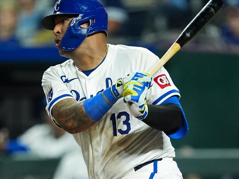 Jul 23, 2024; Kansas City, Missouri, USA; Kansas City Royals first baseman Salvador Perez (13) hits a single during the ninth inning against the Arizona Diamondbacks at Kauffman Stadium. Mandatory Credit: Jay Biggerstaff-USA TODAY Sports