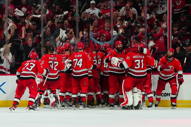 May 11, 2023; Raleigh, North Carolina, USA; Carolina Hurricanes players celebrate their victory against the New Jersey Devils in overtime in game five of the second round of the 2023 Stanley Cup Playoffs at PNC Arena. Mandatory Credit: James Guillory-USA TODAY Sports