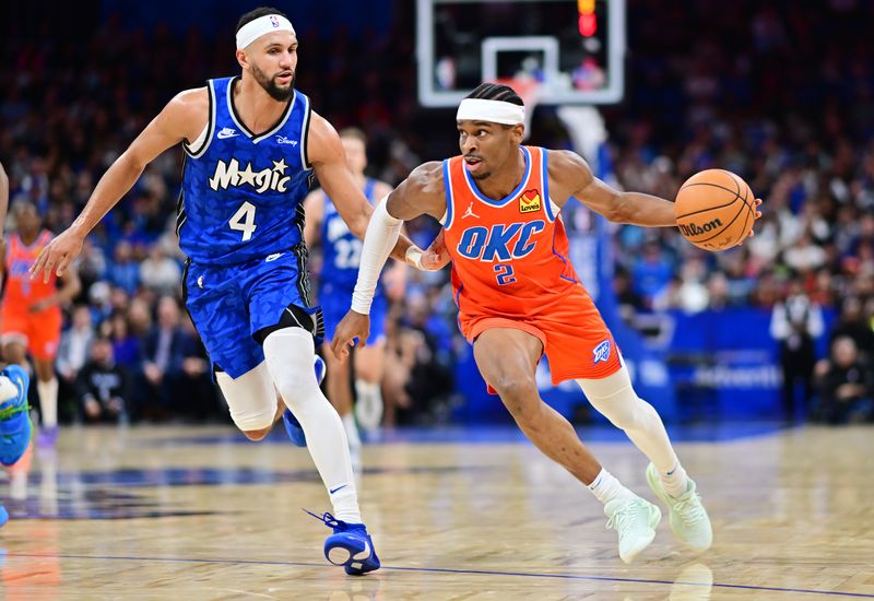 ORLANDO, FLORIDA - FEBRUARY 13: Shai Gilgeous-Alexander #2 of the Oklahoma City Thunder drives to the basket against Jalen Suggs #4 of the Orlando Magic in the second half at Kia Center on February 13, 2024 in Orlando, Florida. NOTE TO USER: User expressly acknowledges and agrees that, by downloading and or using this photograph, User is consenting to the terms and conditions of the Getty Images License Agreement. (Photo by Julio Aguilar/Getty Images)