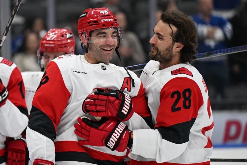 Mar 20, 2026; Toronto, Ontario, CAN;  Carolina Hurricanes forwards Jordan Martinook (48) and William Carrier (28) react in warm ups before playing the Toronto Maple Leafs at Scotiabank Arena. Mandatory Credit: Dan Hamilton-Imagn Images