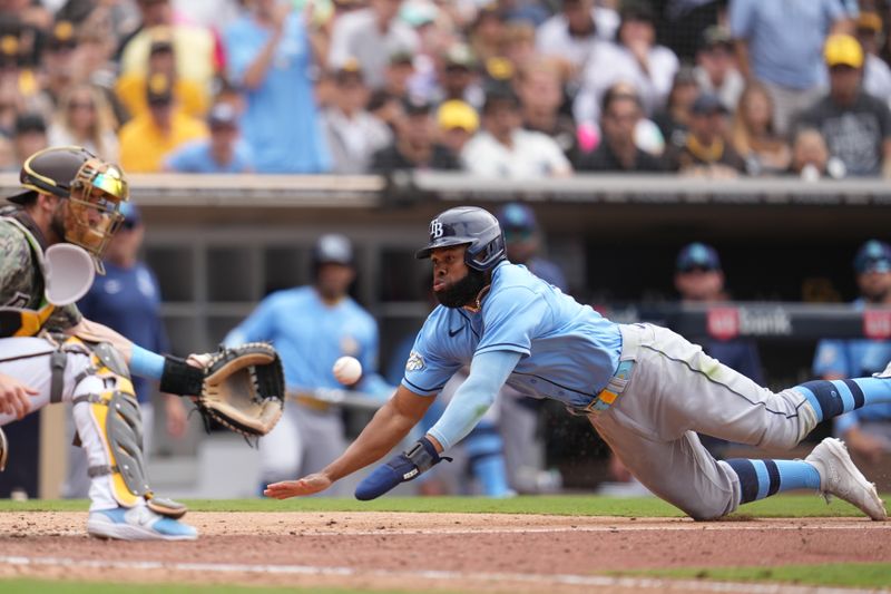 Jun 18, 2023; San Diego, California, USA;  Tampa Bay Rays center fielder Manuel Margot (13) attempts to score against San Diego Padres catcher Austin Nola (26) during the eighth inning at Petco Park. Mandatory Credit: Ray Acevedo-USA TODAY Sports