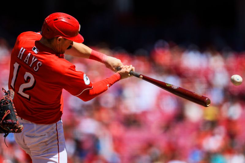 Aug 31, 2025; Cincinnati, Ohio, USA; Cincinnati Reds outfielder Austin Hays (12) hits a double in the seventh inning against the St. Louis Cardinals at Great American Ball Park. Mandatory Credit: Katie Stratman-Imagn Images