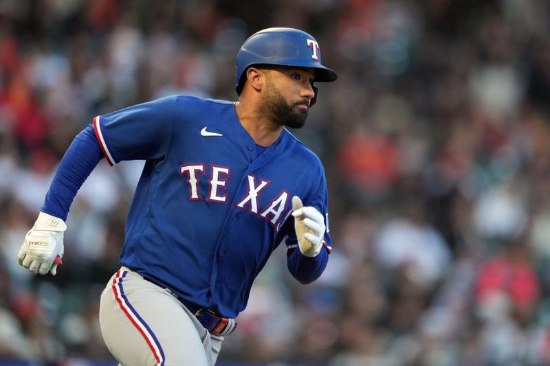 Aug 12, 2023; San Francisco, California, USA; Texas Rangers designated hitter Ezequiel Duran (20) runs to first base after hitting an RBI-single against the San Francisco Giants during the fifth inning at Oracle Park. Mandatory Credit: Darren Yamashita-USA TODAY Sports