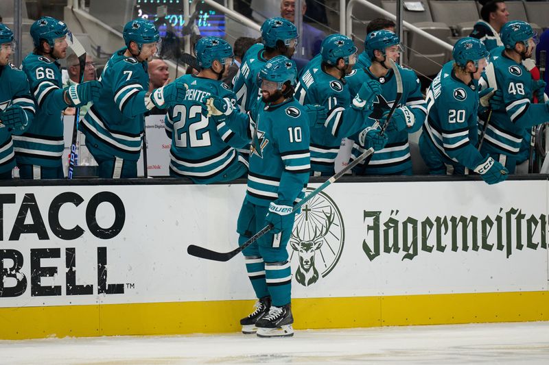 Nov 7, 2023; San Jose, California, USA; San Jose Sharks left wing Anthony Duclair (10) shakes hands with players on the Sharks bench after scoring a goal against the Philadelphia Flyers during the first period at SAP Center at San Jose. Mandatory Credit: Robert Edwards-USA TODAY Sports