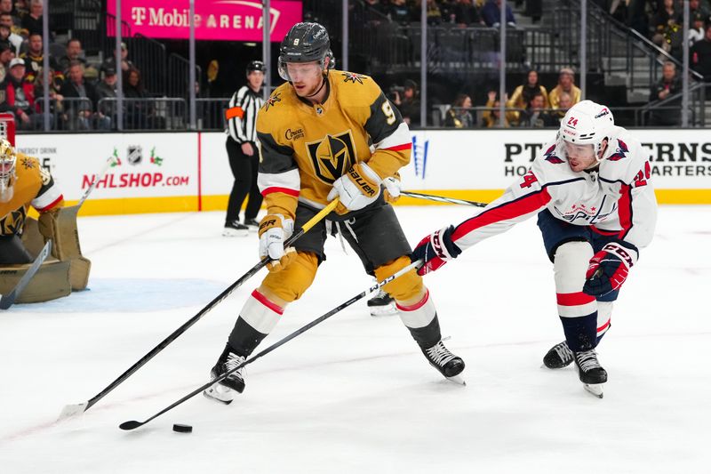 Dec 2, 2023; Las Vegas, Nevada, USA; Vegas Golden Knights center Jack Eichel (9) protects the puck from the stick of Washington Capitals center Connor McMichael (24) during the first period at T-Mobile Arena. Mandatory Credit: Stephen R. Sylvanie-USA TODAY Sports