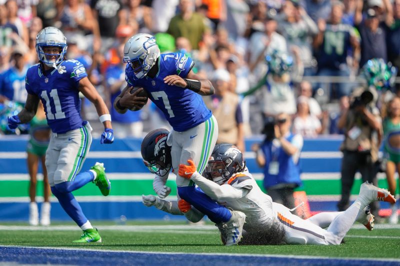 Seattle Seahawks quarterback Geno Smith (7) scores a touchdown during the first half of an NFL football game against the Denver Broncos, Sunday, Sept. 8, 2024, in Seattle. (AP Photo/Lindsey Wasson)