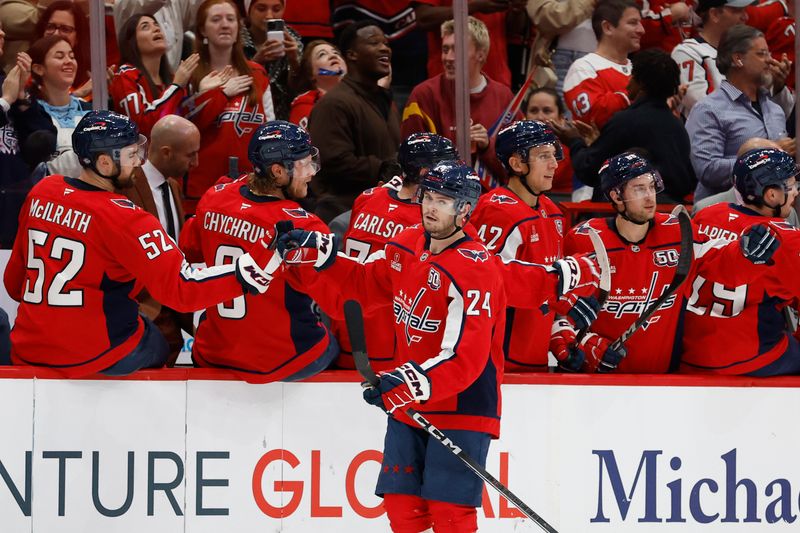 Oct 23, 2024; Washington, District of Columbia, USA; Washington Capitals center Connor McMichael (24) celebrates with teammates after scoring a goal against the Philadelphia Flyers in the second period at Capital One Arena. Mandatory Credit: Geoff Burke-Imagn Images