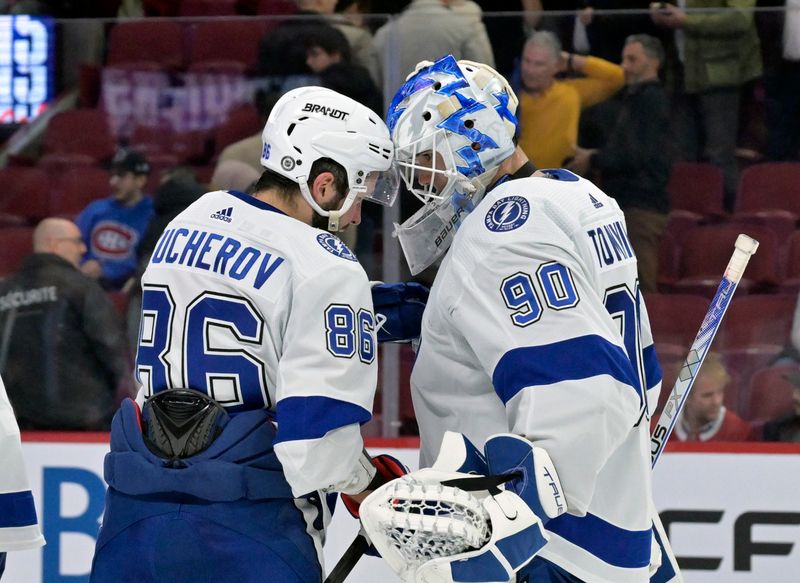 Nov 7, 2023; Montreal, Quebec, CAN; Tampa Bay Lightning forward Nikita Kucherov (86) and teammate goalie Matt Tomkins (90) celebrate the win against the Montreal Canadiens at the Bell Centre. Mandatory Credit: Eric Bolte-USA TODAY Sports