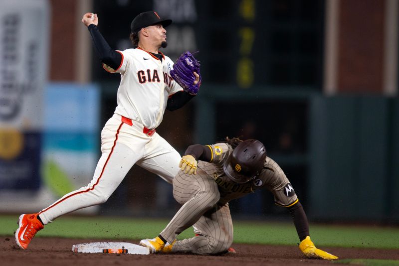 Jun 2, 2025; San Francisco, California, USA; San Francisco Giants shortstop Willy Adames (2) throws over San Diego Padres right fielder Fernando Tatis Jr. (23) but is too late to double up Luis Arraez at first during the eighth inning at Oracle Park. Mandatory Credit: D. Ross Cameron-Imagn Images
