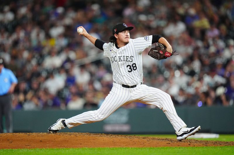 Aug 16, 2024; Denver, Colorado, USA; Colorado Rockies relief pitcher Victor Vodnik (38) delivers at pitch in the ninth inning against the San Diego Padres at Coors Field. Mandatory Credit: Ron Chenoy-USA TODAY Sports