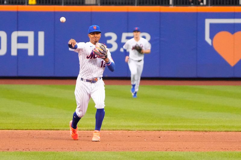 Jul 16, 2023; New York City, New York, USA; New York Mets shortstop Francisco Lindor (12) throws out Los Angeles Dodgers shortstop Miguel Rojas (not pictured) after fielding a ground ball during the fifth inning at Citi Field. Mandatory Credit: Gregory Fisher-USA TODAY Sports