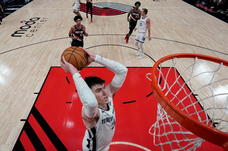 PORTLAND, OREGON - NOVEMBER 10: Jake LaRavia #3 of the Memphis Grizzlies dunks the ball during the first half against the Portland Trail Blazers at Moda Center on November 10, 2024 in Portland, Oregon. NOTE TO USER: User expressly acknowledges and agrees that, by downloading and or using this photograph, User is consenting to the terms and conditions of the Getty Images License Agreement. (Photo by Soobum Im/Getty Images)