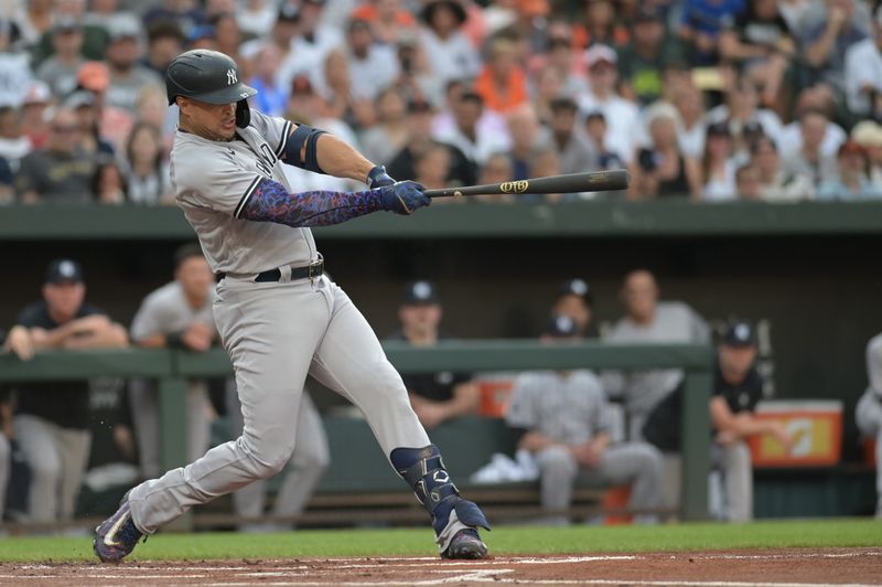 Jul 29, 2023; Baltimore, Maryland, USA;  New York Yankees designated hitter Giancarlo Stanton (27) hits a solo home run in the first inning against the Baltimore Orioles at Oriole Park at Camden Yards. Mandatory Credit: Tommy Gilligan-USA TODAY Sports