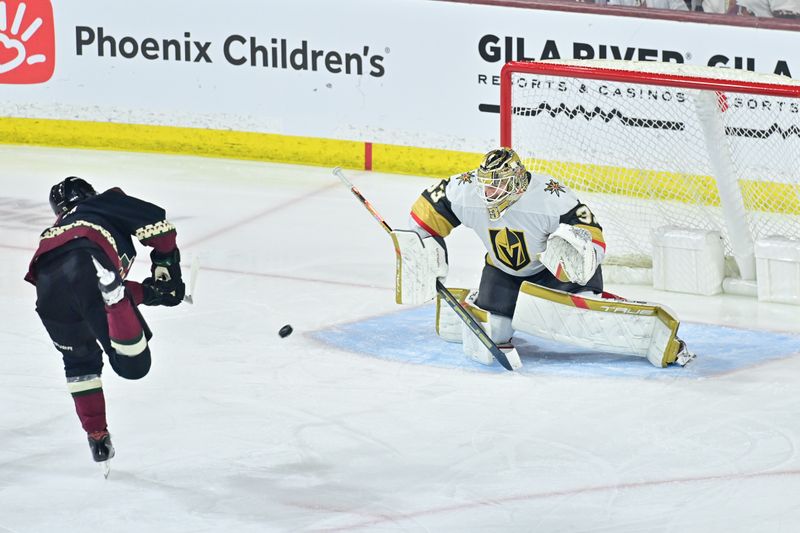 Feb 8, 2024; Tempe, Arizona, USA; Arizona Coyotes right wing Clayton Keller (9) scores on Vegas Golden Knights goaltender Adin Hill (33) in the third period at Mullett Arena. Mandatory Credit: Matt Kartozian-USA TODAY Sports