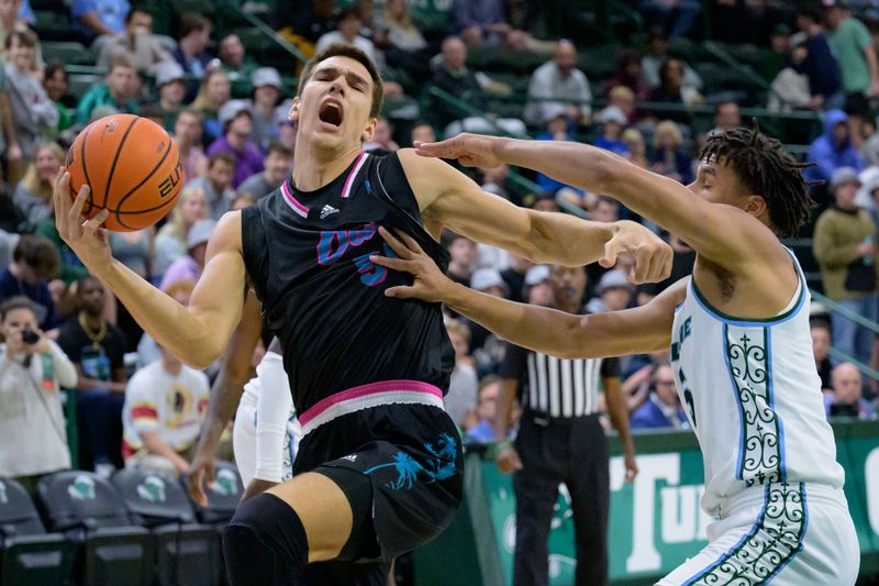 Jan 11, 2024; New Orleans, Louisiana, USA; Florida Atlantic Owls center Vladislav Goldin (50) is fouled by Tulane Green Wave forward Collin Holloway (5) during the first half at Avron B. Fogelman Arena in Devlin Fieldhouse. Mandatory Credit: Matthew Hinton-USA TODAY Sports