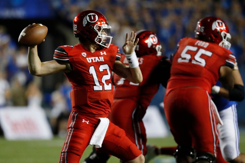 Sep 11, 2021; Provo, Utah, USA; Utah Utes quarterback Charlie Brewer (12) looks to pass in the first quarter against the Brigham Young Cougars at LaVell Edwards Stadium. Mandatory Credit: Jeffrey Swinger-USA TODAY Sports