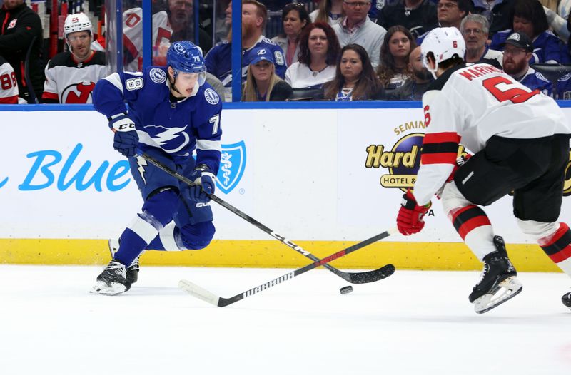 Jan 27, 2024; Tampa, Florida, USA; Tampa Bay Lightning defenseman Emil Martinsen Lilleberg (78) skates with the puck as New Jersey Devils defenseman John Marino (6) defends during the first period at Amalie Arena. Mandatory Credit: Kim Klement Neitzel-USA TODAY Sports