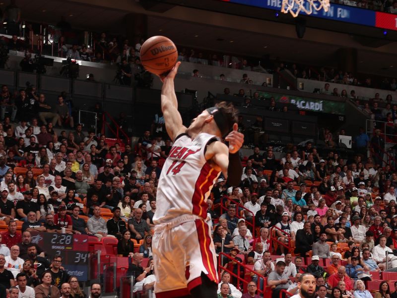 MIAMI, FL - APRIL 19: Tyler Herro #14 of the Miami Heat grabs the rebound during the game against the Chicago Bulls during the 2024 Play-In Tournament on April 19, 2024 at Kaseya Center in Miami, Florida. NOTE TO USER: User expressly acknowledges and agrees that, by downloading and or using this Photograph, user is consenting to the terms and conditions of the Getty Images License Agreement. Mandatory Copyright Notice: Copyright 2024 NBAE (Photo by Issac Baldizon/NBAE via Getty Images)