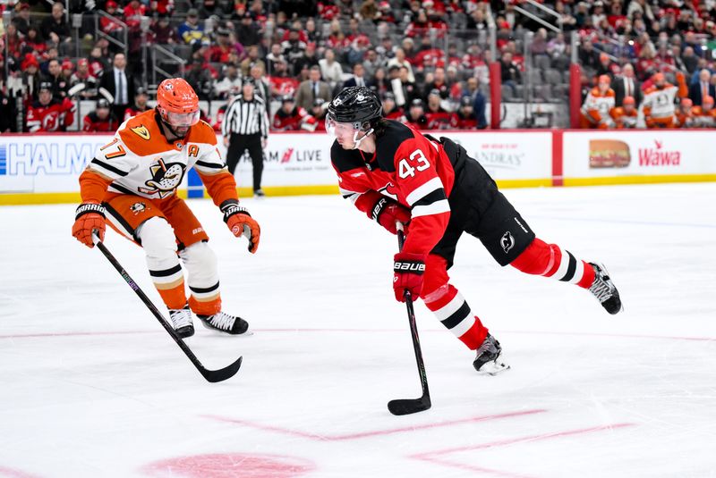 Dec 13, 2025; Newark, New Jersey, USA; New Jersey Devils defenseman Luke Hughes (43) skates against Anaheim Ducks left wing Alex Killorn (17) during the second period at Prudential Center. Mandatory Credit: John Jones-Imagn Images