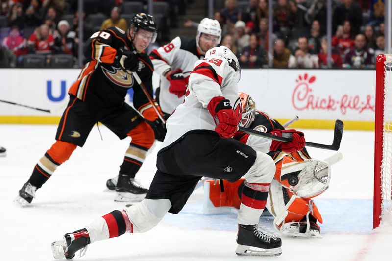 Mar 1, 2024; Anaheim, California, USA; New Jersey Devils center Nico Hischier (13) shoots the puck against Anaheim Ducks goaltender Lukas Dostal (1) during the third period at Honda Center. Mandatory Credit: Kiyoshi Mio-USA TODAY Sports