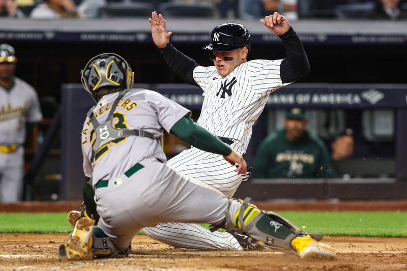 Apr 24, 2024; Bronx, New York, USA; New York Yankees first baseman Anthony Rizzo (48) is tagged out at home plate by Oakland Athletics catcher Shea Langeliers (23) in the seventh inning at Yankee Stadium. Mandatory Credit: Wendell Cruz-USA TODAY Sports