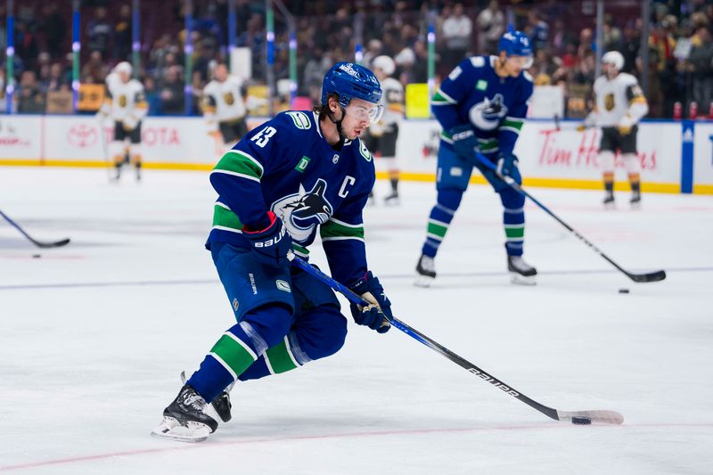 Nov 30, 2023; Vancouver, British Columbia, CAN; Vancouver Canucks defenseman Quinn Hughes (43) handles the puck during warm up prior to a game against the Vegas Golden Knights at Rogers Arena. Mandatory Credit: Bob Frid-USA TODAY Sports