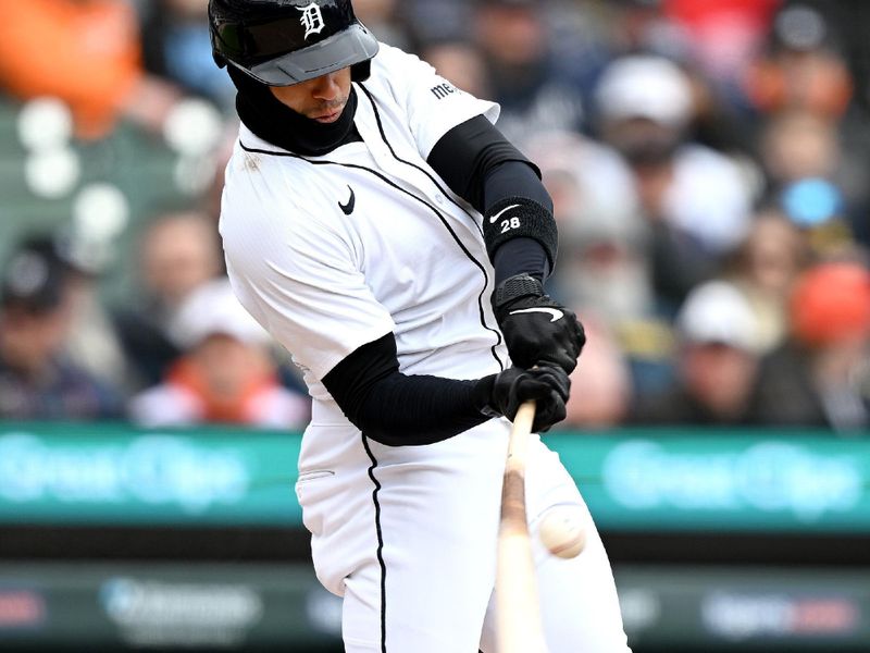 Apr 6, 2025; Detroit, Michigan, USA; Detroit Tigers shortstop Javier Báez (28) hits an RBI single against the Chicago White Sox in the second inning at Comerica Park. Mandatory Credit: Lon Horwedel-Imagn Images