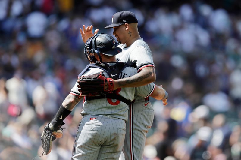 Jun 30, 2024; Seattle, Washington, USA; Minnesota Twins left fielder Trevor Larnach (9) and Minnesota Twins pitcher Jhoan Duran (59) hug at the end of the game against the Seattle Mariners at T-Mobile Park. Mandatory Credit: John Froschauer-USA TODAY Sports