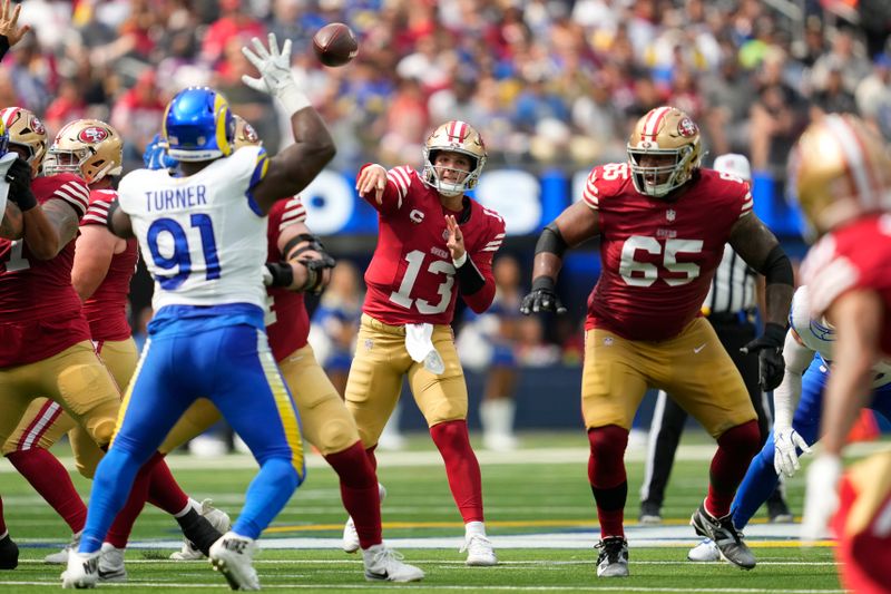 San Francisco 49ers quarterback Brock Purdy (13) passes against the Los Angeles Rams during the first half of an NFL football game, Sunday, Sept. 22, 2024, in Inglewood, Calif. (AP Photo/Ashley Landis)