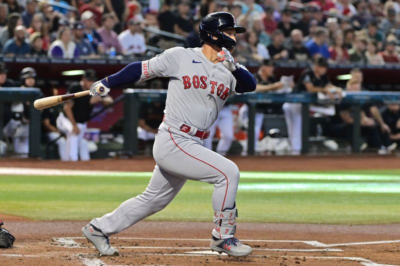 May 27, 2023; Phoenix, Arizona, USA;  Boston Red Sox left fielder Masataka Yoshida (7) singles against the Arizona Diamondbacks in the first inning at Chase Field. Mandatory Credit: Matt Kartozian-USA TODAY Sports