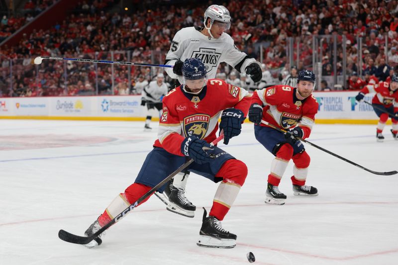 Dec 17, 2025; Sunrise, Florida, USA; Florida Panthers defenseman Seth Jones (3) protects the puck from Los Angeles Kings right wing Quinton Byfield (55) during the first period at Amerant Bank Arena. Mandatory Credit: Sam Navarro-Imagn Images