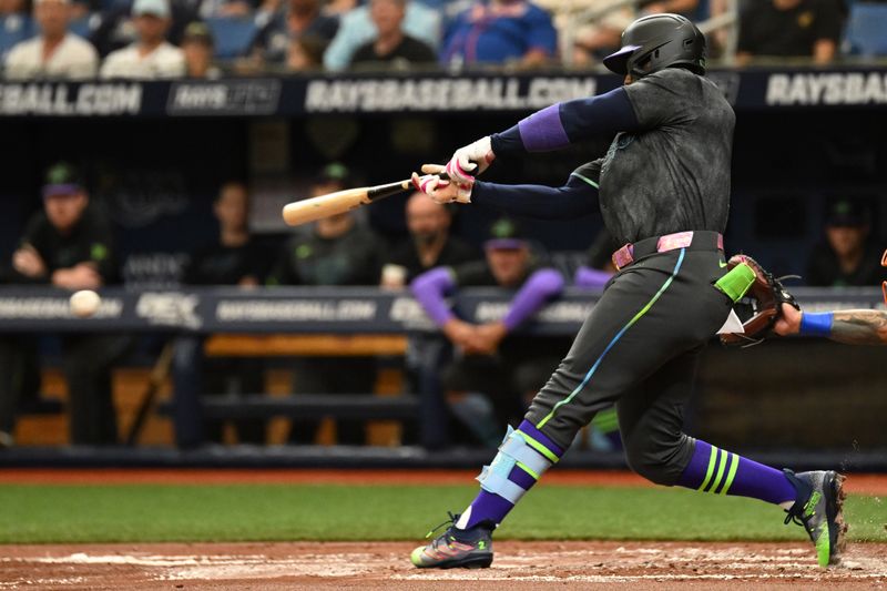 May 5, 2024; St. Petersburg, Florida, USA; Tampa Bay Rays first baseman Yandy Diaz (2) hits a two run single in the second inning against the New York Mets at Tropicana Field. Mandatory Credit: Jonathan Dyer-USA TODAY Sports