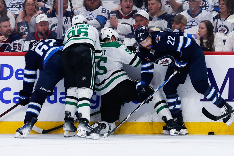 May 15, 2025; Winnipeg, Manitoba, CAN; Winnipeg Jets forward Mason Appleton (22) and Dallas Stars defenseman Thomas Harley (55) battle for the puck during the second period in game five of the second round of the 2025 Stanley Cup Playoffs at Canada Life Centre. Mandatory Credit: Terrence Lee-Imagn Images