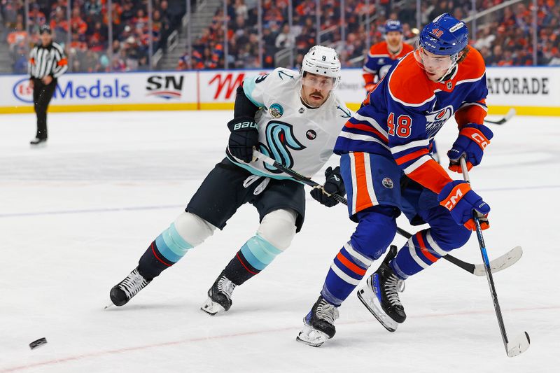 Jan 27, 2025; Edmonton, Alberta, CAN; Edmonton Oilers forward Noah Philp (48) looks for a pass in front of Seattle Kraken forward Chandler Stephenson (9) during the first period at Rogers Place. Mandatory Credit: Perry Nelson-Imagn Images