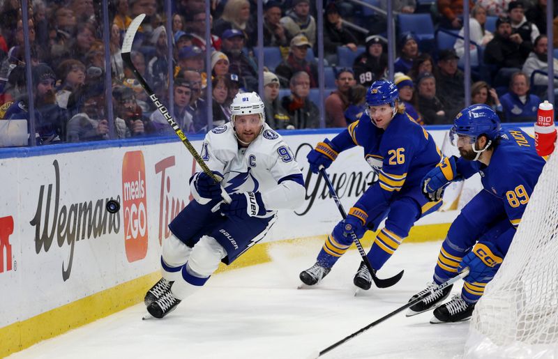 Jan 20, 2024; Buffalo, New York, USA;  Buffalo Sabres defenseman Rasmus Dahlin (26) watches as Tampa Bay Lightning center Steven Stamkos (91) clears the puck behind the net during the third period at KeyBank Center. Mandatory Credit: Timothy T. Ludwig-USA TODAY Sports