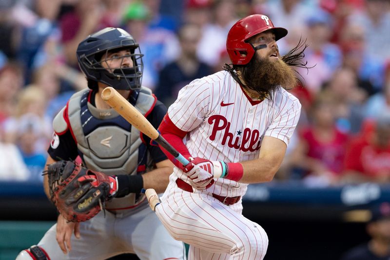 Jul 27, 2024; Philadelphia, Pennsylvania, USA;  Philadelphia Phillies outfielder Brandon Marsh (16) hits a two RBI home run in front of Cleveland Guardians catcher Austin Hedges (27) during the fourth inning at Citizens Bank Park. Mandatory Credit: Bill Streicher-USA TODAY Sports