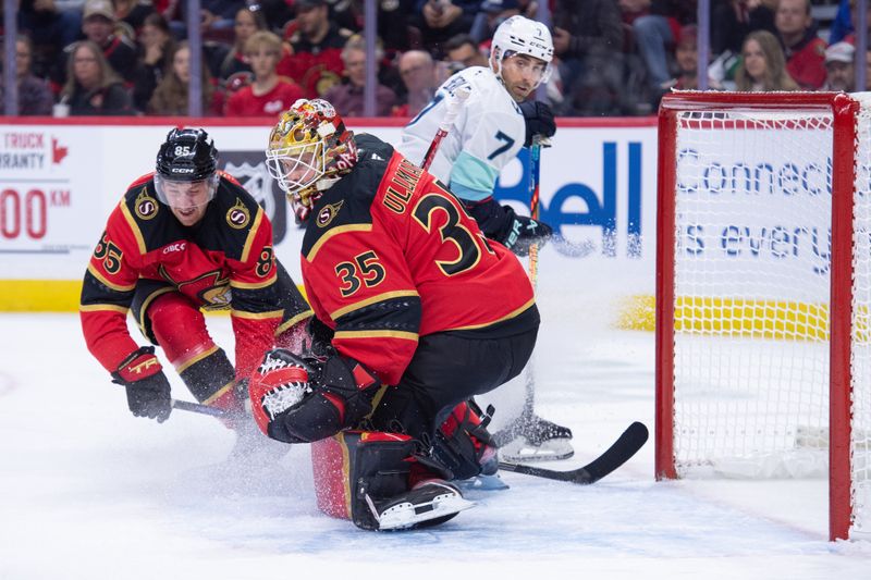 Oct 16, 2025; Ottawa, Ontario, CAN; Ottawa Senators defenseman Jake Sanderson (85) and goalie Linus Ullmark (35) follow the puck in the second period against the Seattle Kraken at the Canadian Tire Centre. Mandatory Credit: Marc DesRosiers-IMAGN Images