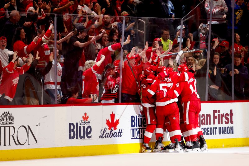 Apr 15, 2024; Detroit, Michigan, USA;  Detroit Red Wings left wing Lucas Raymond (23) receives congratulations from teammates after scoring in the third period against the Montreal Canadiens at Little Caesars Arena. Mandatory Credit: Rick Osentoski-USA TODAY Sports