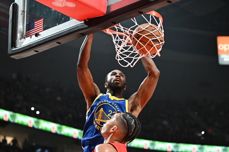 PORTLAND, OREGON - OCTOBER 23: Andrew Wiggins #22 of the Golden State Warriors dunks the ball over Toumani Camara #33 of the Portland Trail Blazers during the first quarter at Moda Center on October 23, 2024 in Portland, Oregon. NOTE TO USER: User expressly acknowledges and agrees that, by downloading and or using this photograph, User is consenting to the terms and conditions of the Getty Images License Agreement. (Photo by Alika Jenner/Getty Images)