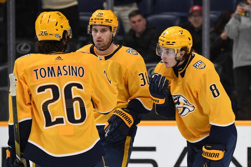 Dec 19, 2023; Nashville, Tennessee, USA; Nashville Predators center Cody Glass (8) celebrates with center Philip Tomasino (26) and left wing Cole Smith (36) after a goal during the third period against the Vancouver Canucks at Bridgestone Arena. Mandatory Credit: Christopher Hanewinckel-USA TODAY Sports