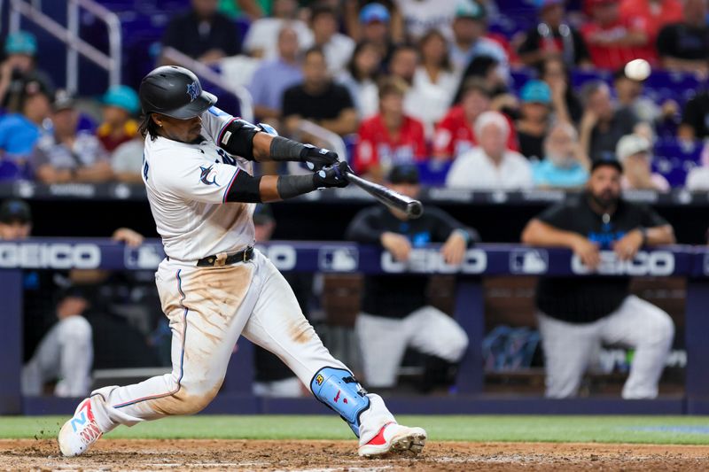 Jul 30, 2023; Miami, Florida, USA; Miami Marlins third baseman Jean Segura (9) hits a solo home run against the Detroit Tigers during the eighth inning at loanDepot Park. Mandatory Credit: Sam Navarro-USA TODAY Sports