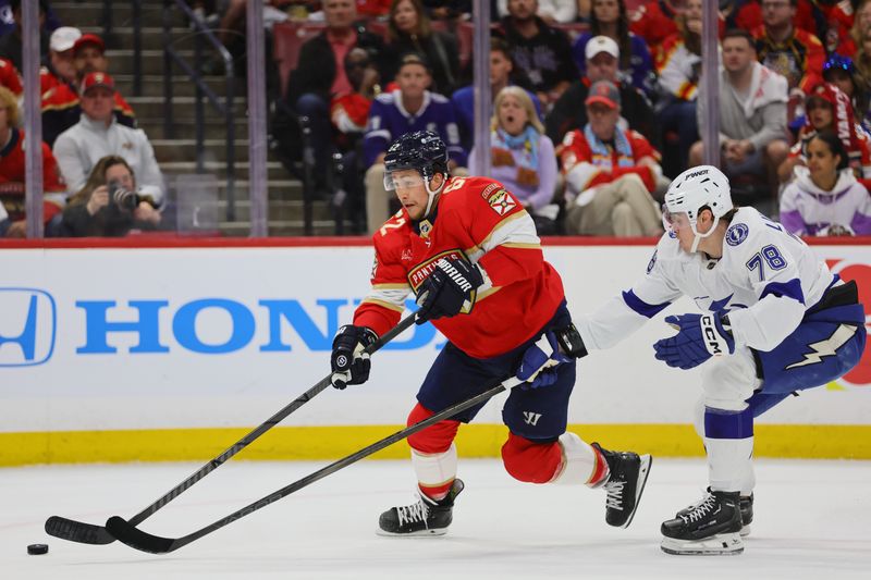 Apr 23, 2024; Sunrise, Florida, USA; Florida Panthers defenseman Brandon Montour (62) moves the puck past Tampa Bay Lightning defenseman Emil Lilleberg (78) during the second period in game two of the first round of the 2024 Stanley Cup Playoffs at Amerant Bank Arena. Mandatory Credit: Sam Navarro-USA TODAY Sports