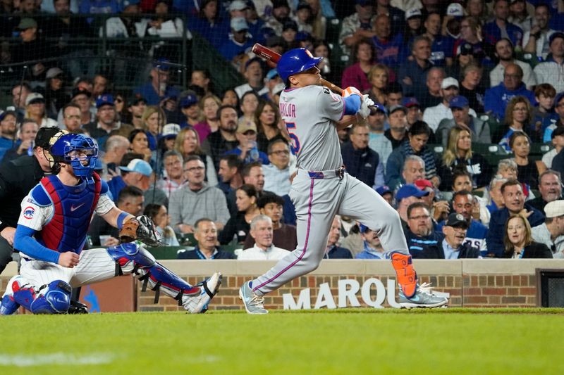 Sep 25, 2025; Chicago, Illinois, USA; New York Mets outfielder Tyrone Taylor (15) hits a two-run double against the Chicago Cubs during the sixth inning at Wrigley Field. Mandatory Credit: David Banks-Imagn Images