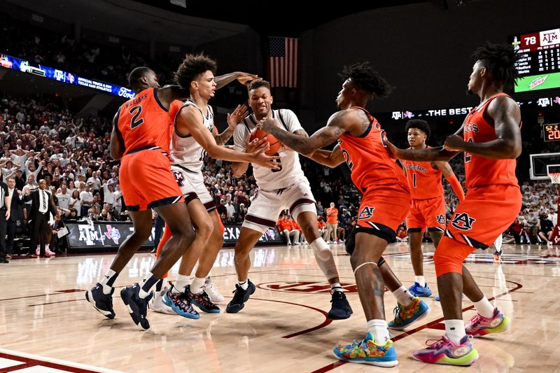 Feb 7, 2023; College Station, Texas, USA; Texas A&M Aggies guard Dexter Dennis (0) battles for a rebound during the second half against the Auburn Tigers at Reed Arena. Mandatory Credit: Maria Lysaker-USA TODAY Sports