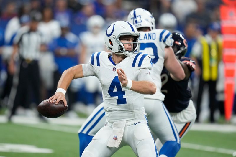 Indianapolis Colts quarterback Sam Ehlinger (4) looks for a receiver during the second half of the team's NFL preseason football game against the Chicago Bears in Indianapolis, Saturday, Aug. 19, 2023. (AP Photo/Michael Conroy)