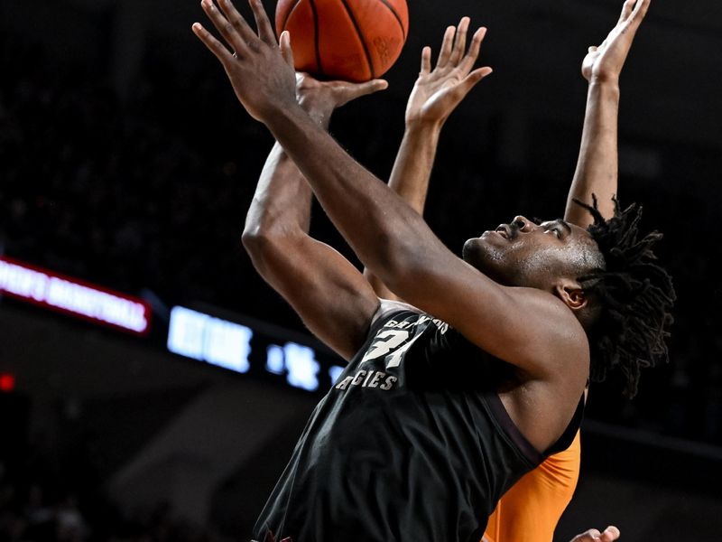 Feb 21, 2023; College Station, Texas, USA;  Tennessee Volunteers forward Jonas Aidoo (0) fouls Texas A&M Aggies forward Julius Marble (34) during the second half at Reed Arena. Mandatory Credit: Maria Lysaker-USA TODAY Sports