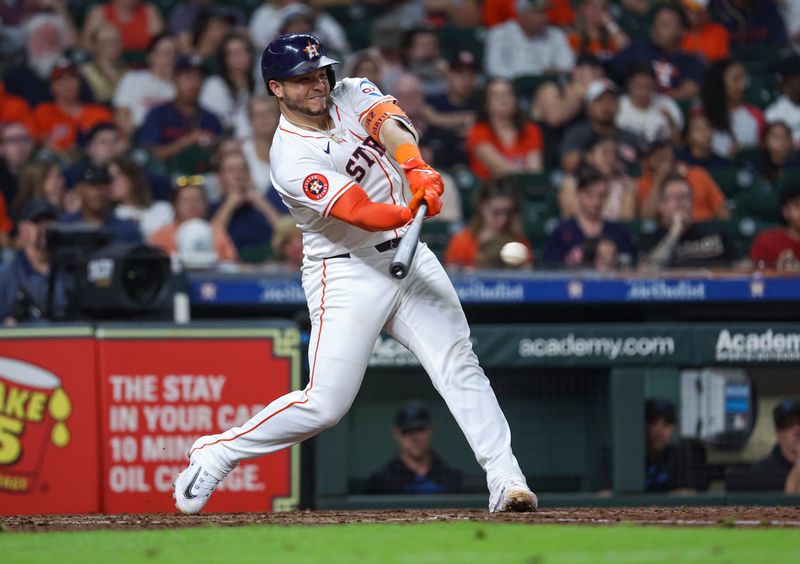 Jul 10, 2024; Houston, Texas, USA; Houston Astros catcher Yainer Diaz (21) hits a single during the fourth inning against the Miami Marlins at Minute Maid Park. Mandatory Credit: Troy Taormina-USA TODAY Sports
