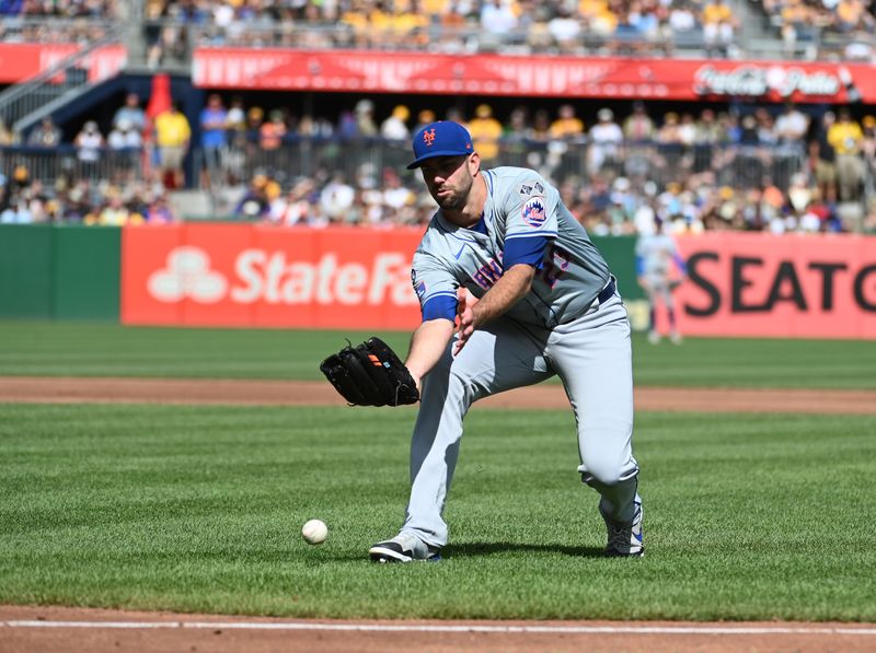 Jul 6, 2024; Pittsburgh, Pennsylvania, USA;  New York Mets starting pitcher David Peterson (23) misplays a second-inning ball against the Pittsburgh Pirates at PNC Park. Mandatory Credit: Philip G. Pavely-USA TODAY Sports