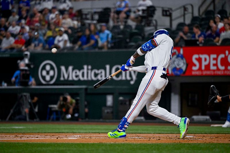 Sep 5, 2024; Arlington, Texas, USA; Texas Rangers right fielder Adolis Garcia (53) hits a three run home run against the Los Angeles Angels during the first inning at Globe Life Field. Mandatory Credit: Jerome Miron-Imagn Images